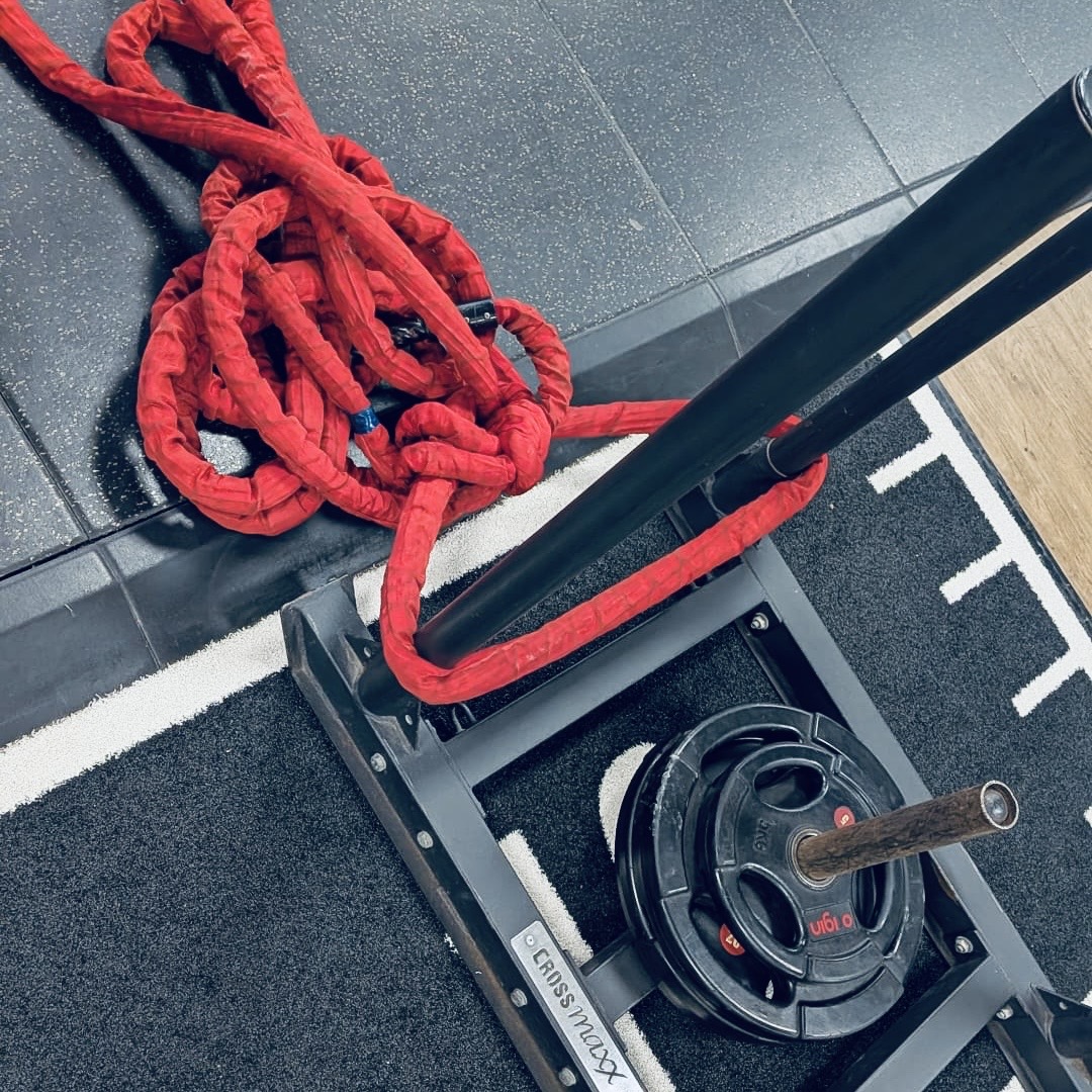 Ashley training with the sled and battle ropes
