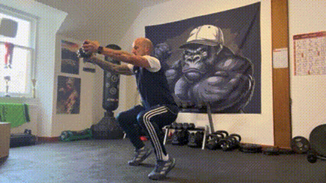 Squat to tip toes with dumbbell