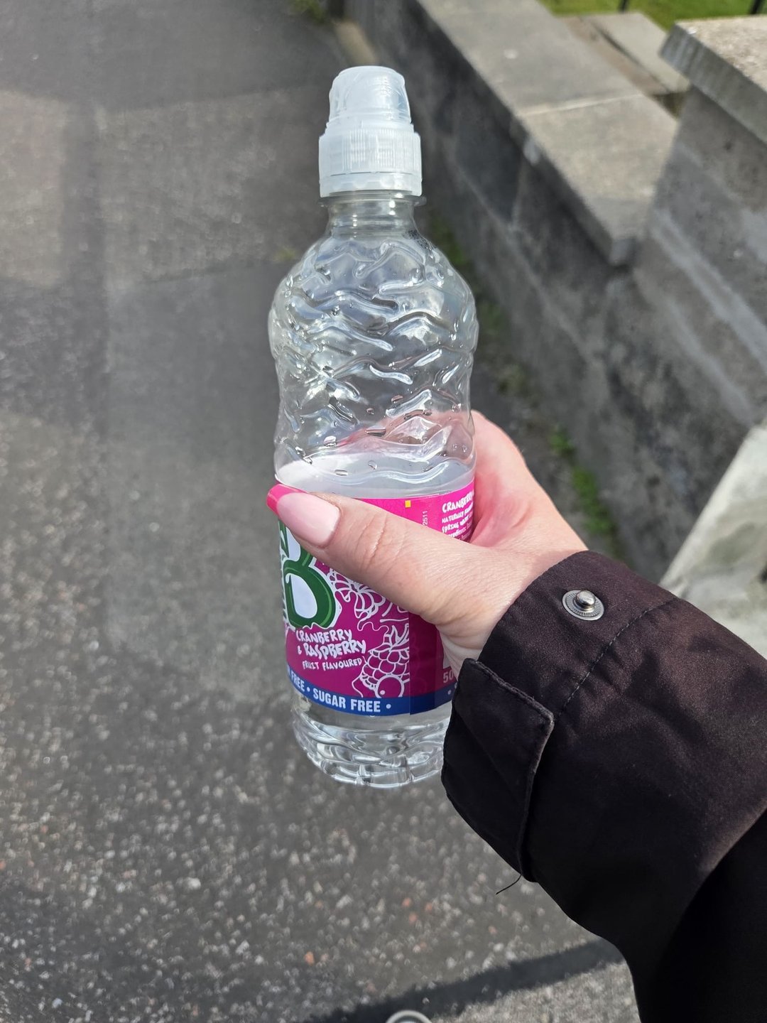 Gemma holding a bottle of water on her walk home