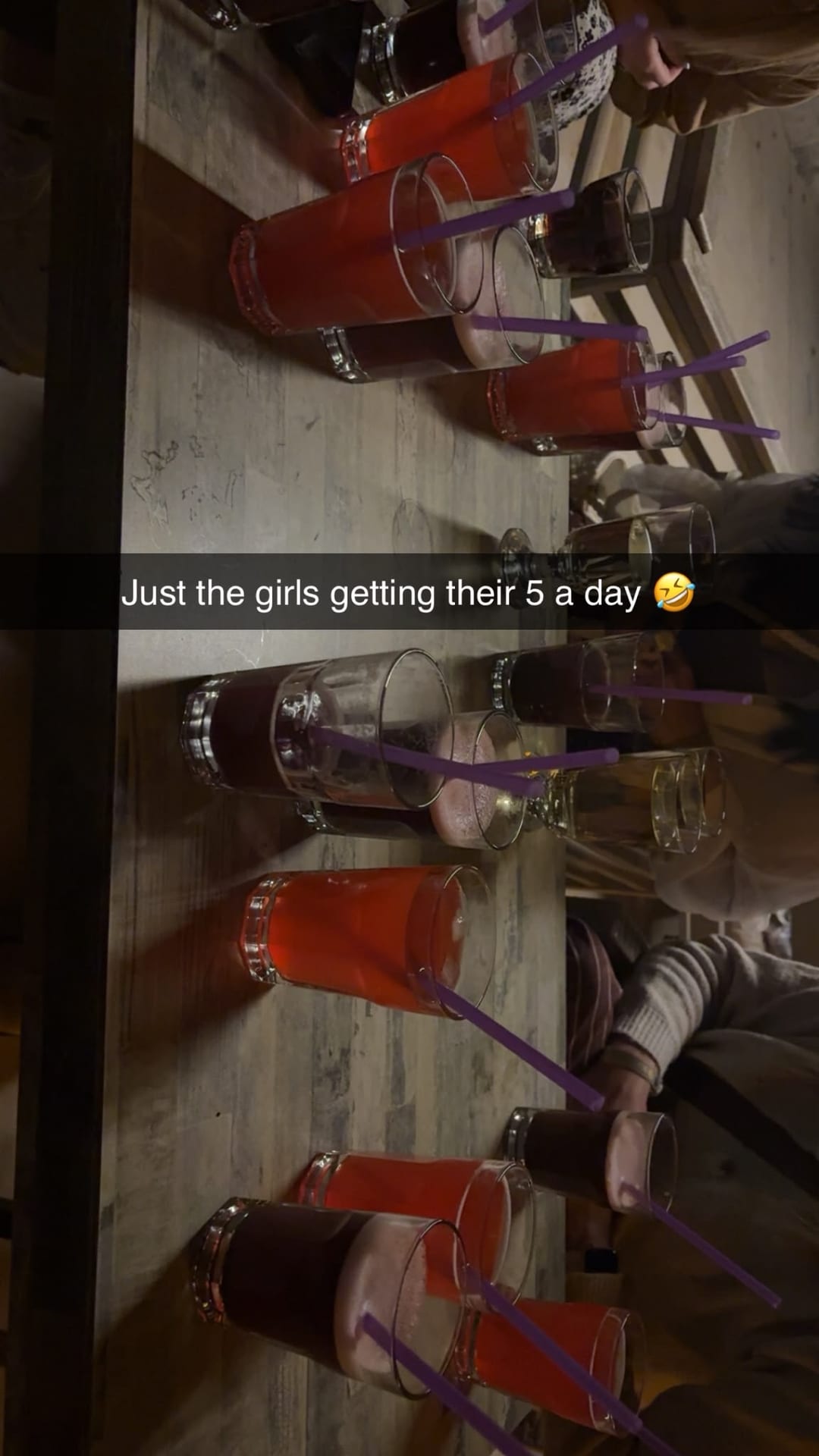 A table of cocktails with straws, captioned just the girls getting their five a day