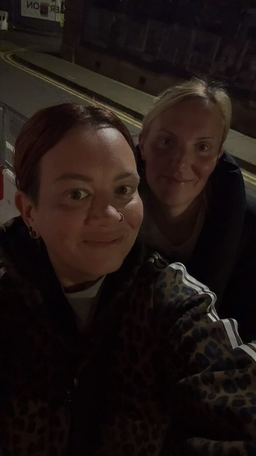 Sarah, in front, out walking at night with a friend